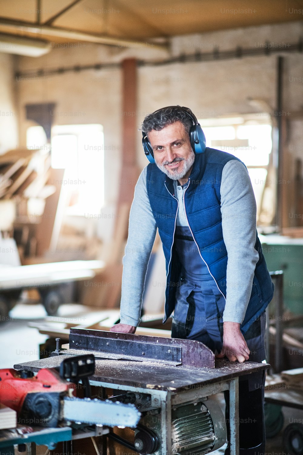 A portrait of a mature man worker in the carpentry workshop.