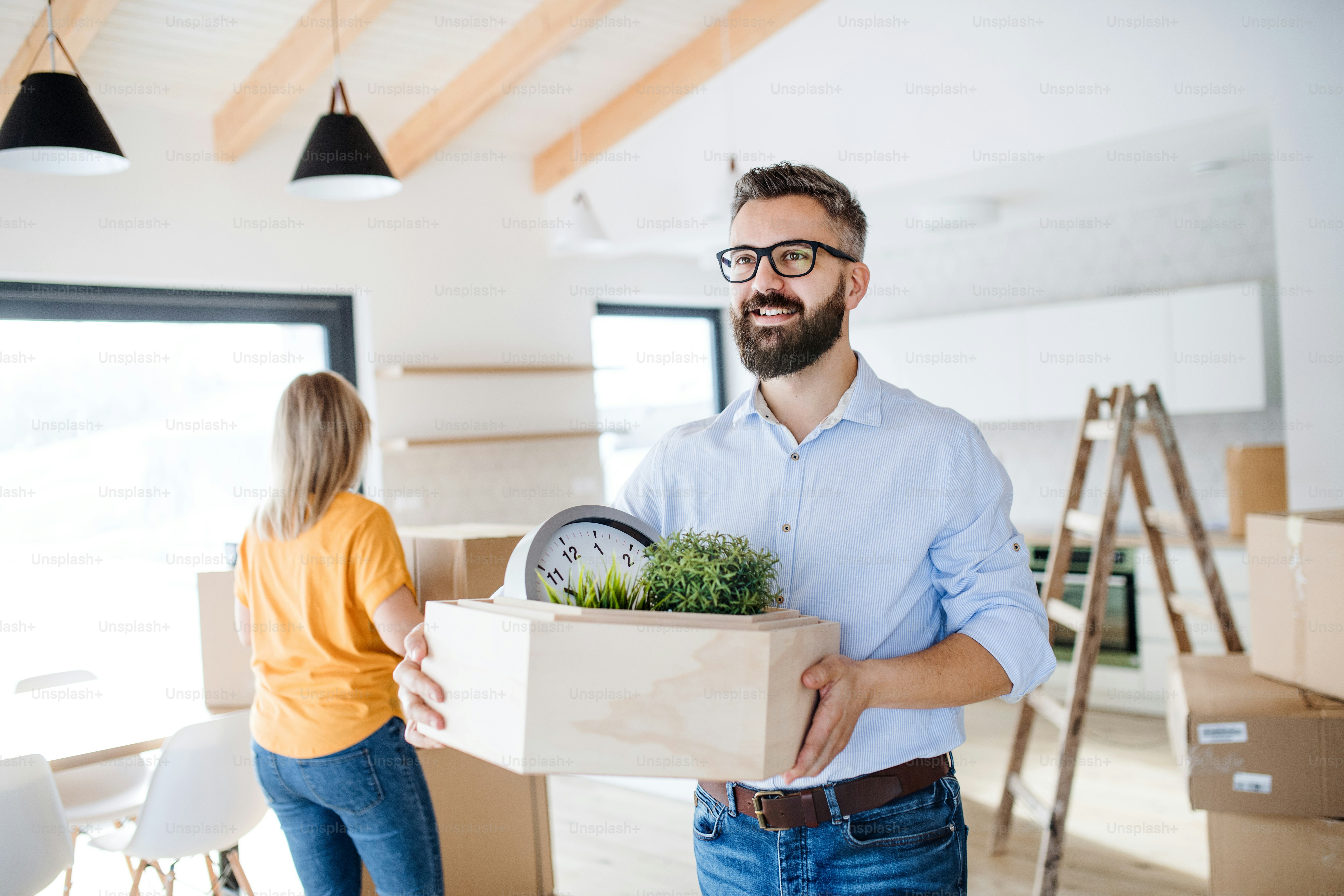A young happy couple furnishing new house, a moving in new home concept ...