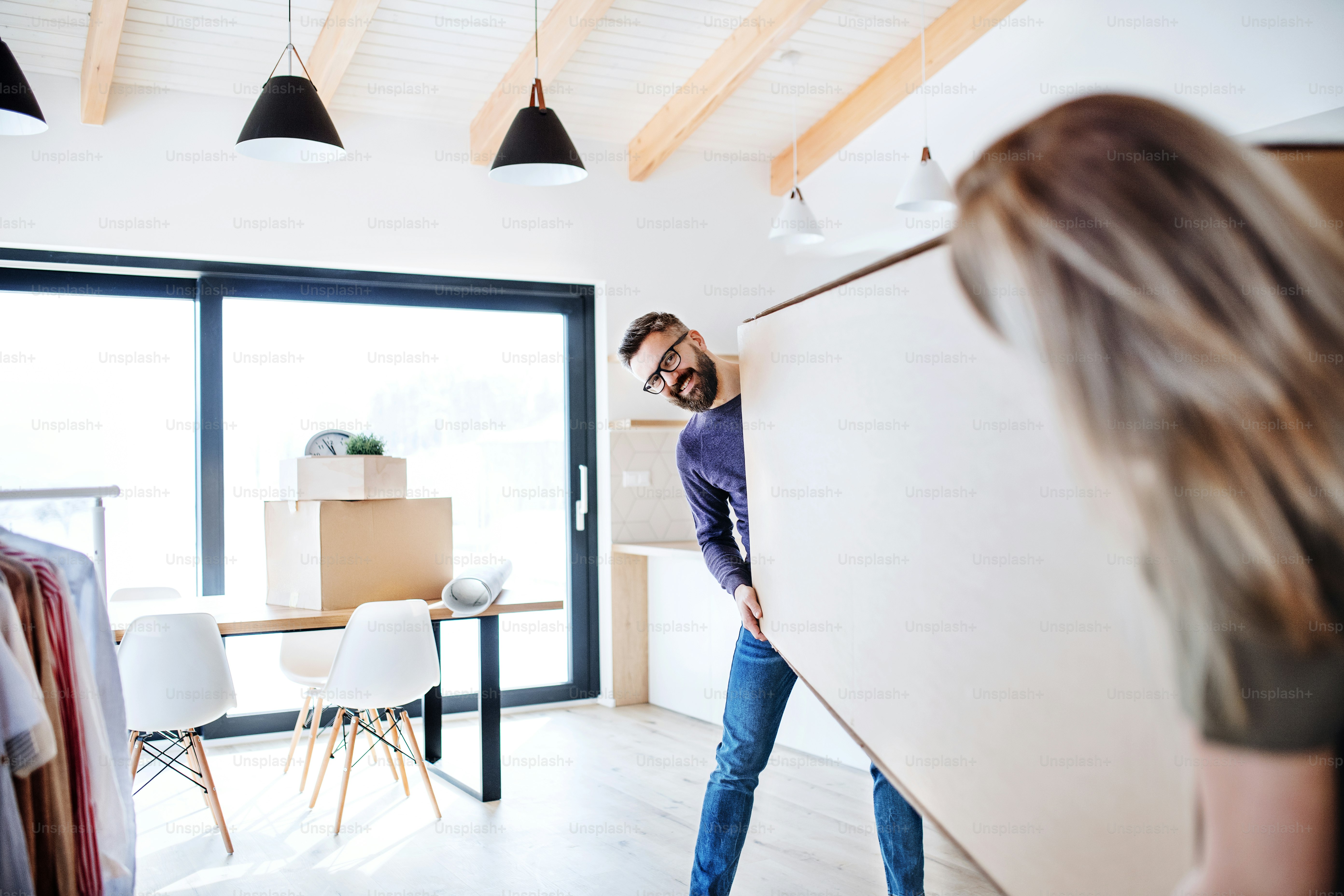 A young happy couple furnishing new house, a moving in new home concept.