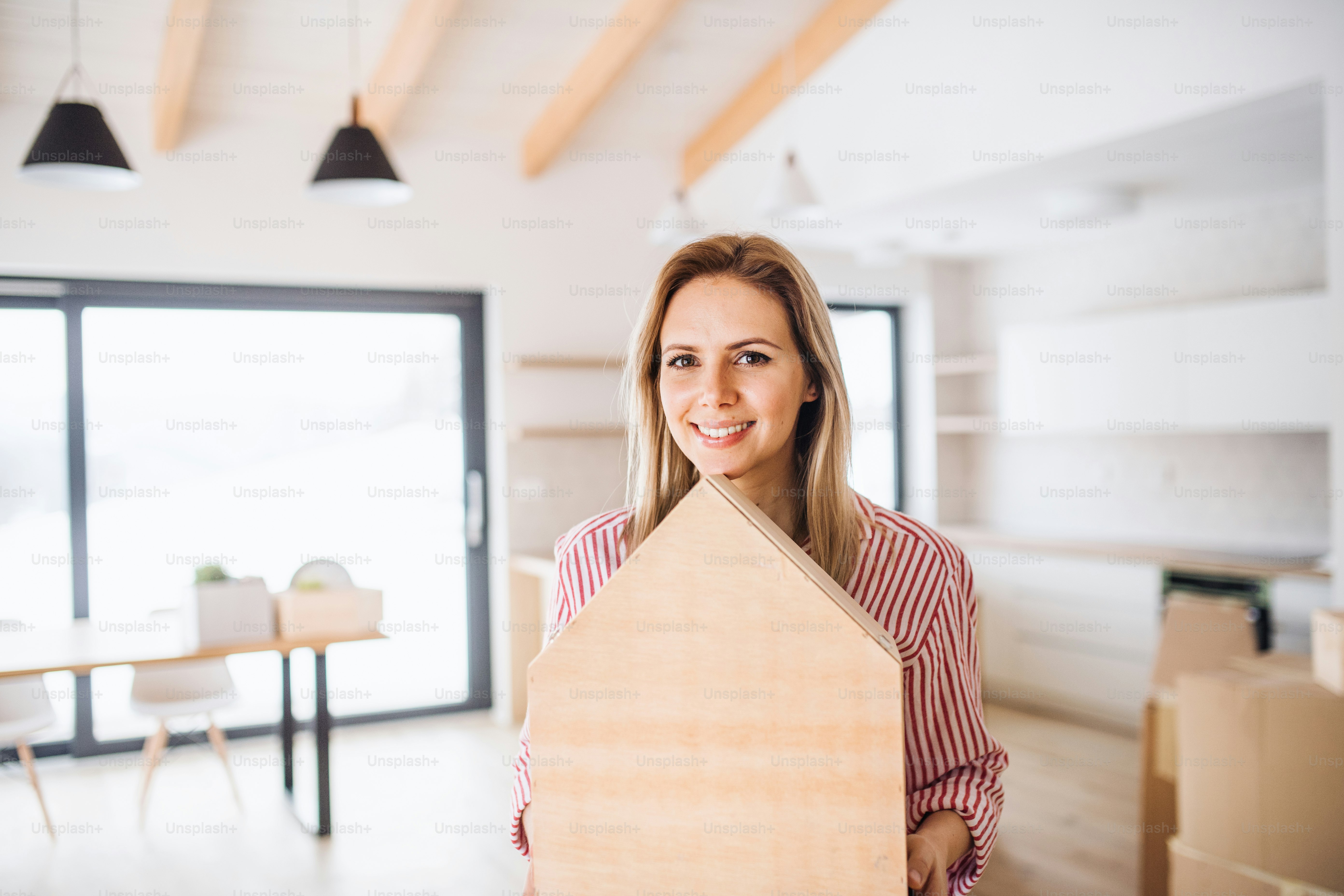 A young woman moving in new home, a concept. Copy space. photo – Woman ...