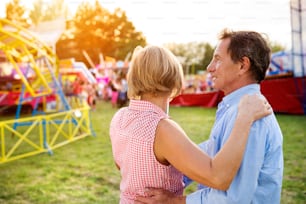 Senior couple having a good time at the fun fair