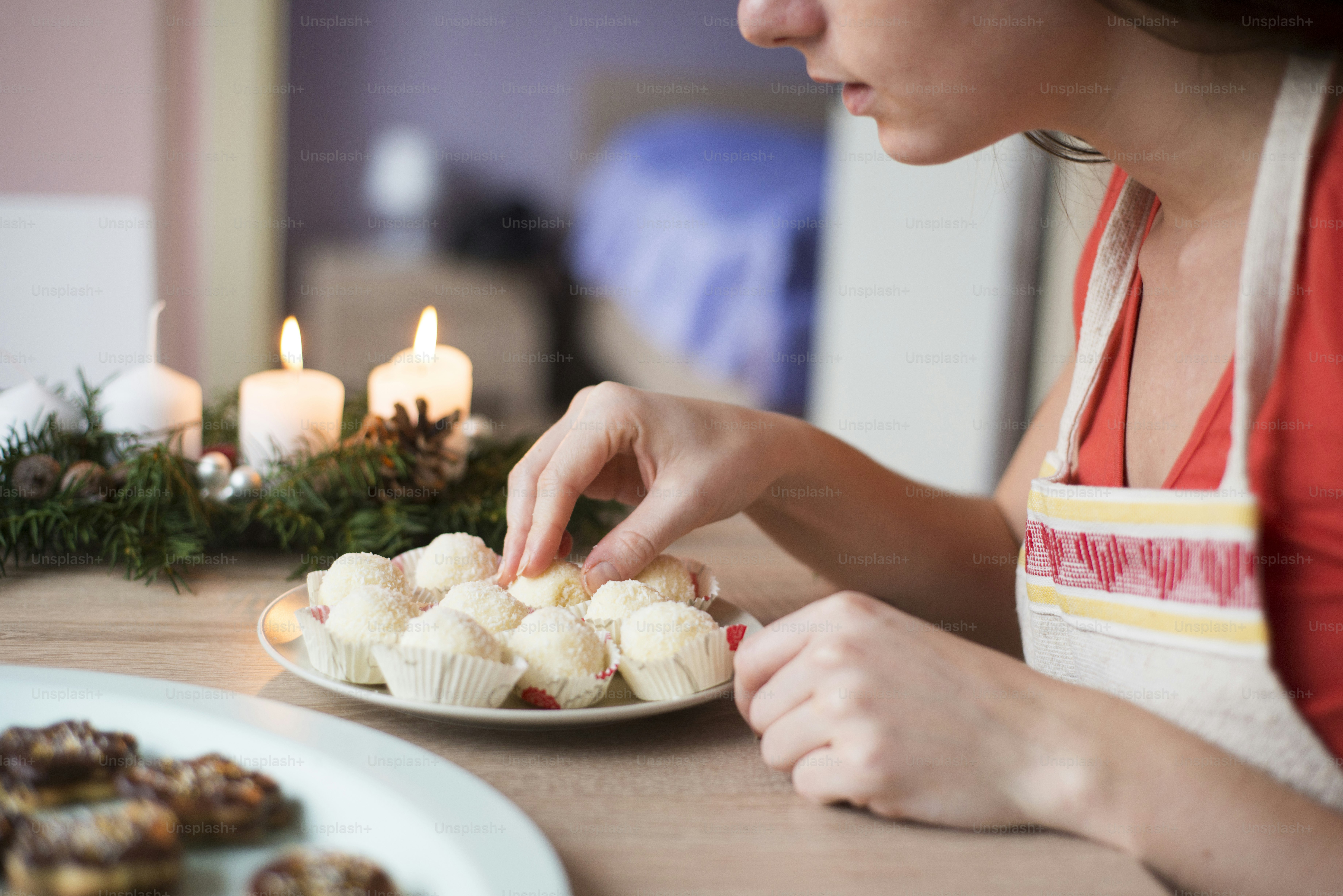 Woman is making christmas cakes in the kitchen