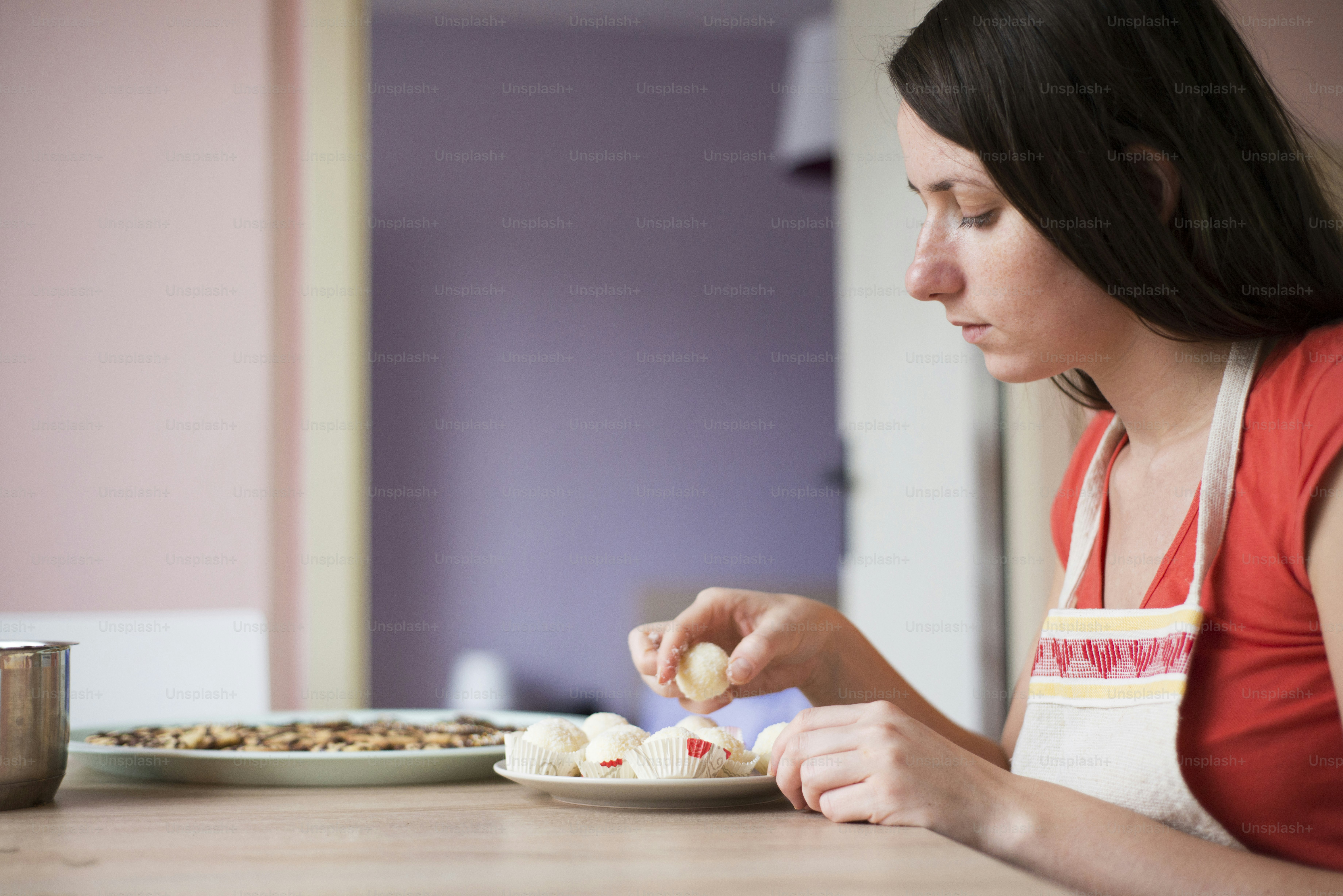 Woman is making christmas cakes in the kitchen