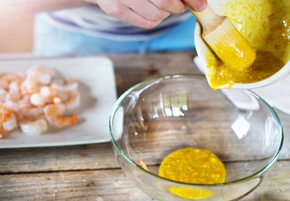 Man in the kitchen preparing prawns for a dinner