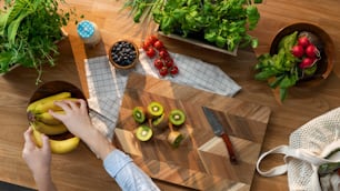 A top view of unrecognizable woman preparing fruit and vegetables, sustainable lifestyle.