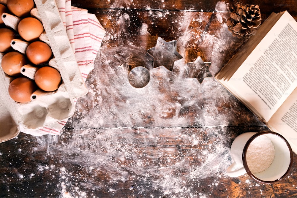 Baking gingerbread cookies at Christmas time. Ingredients on the wooden table. Overhead view. Copy space.