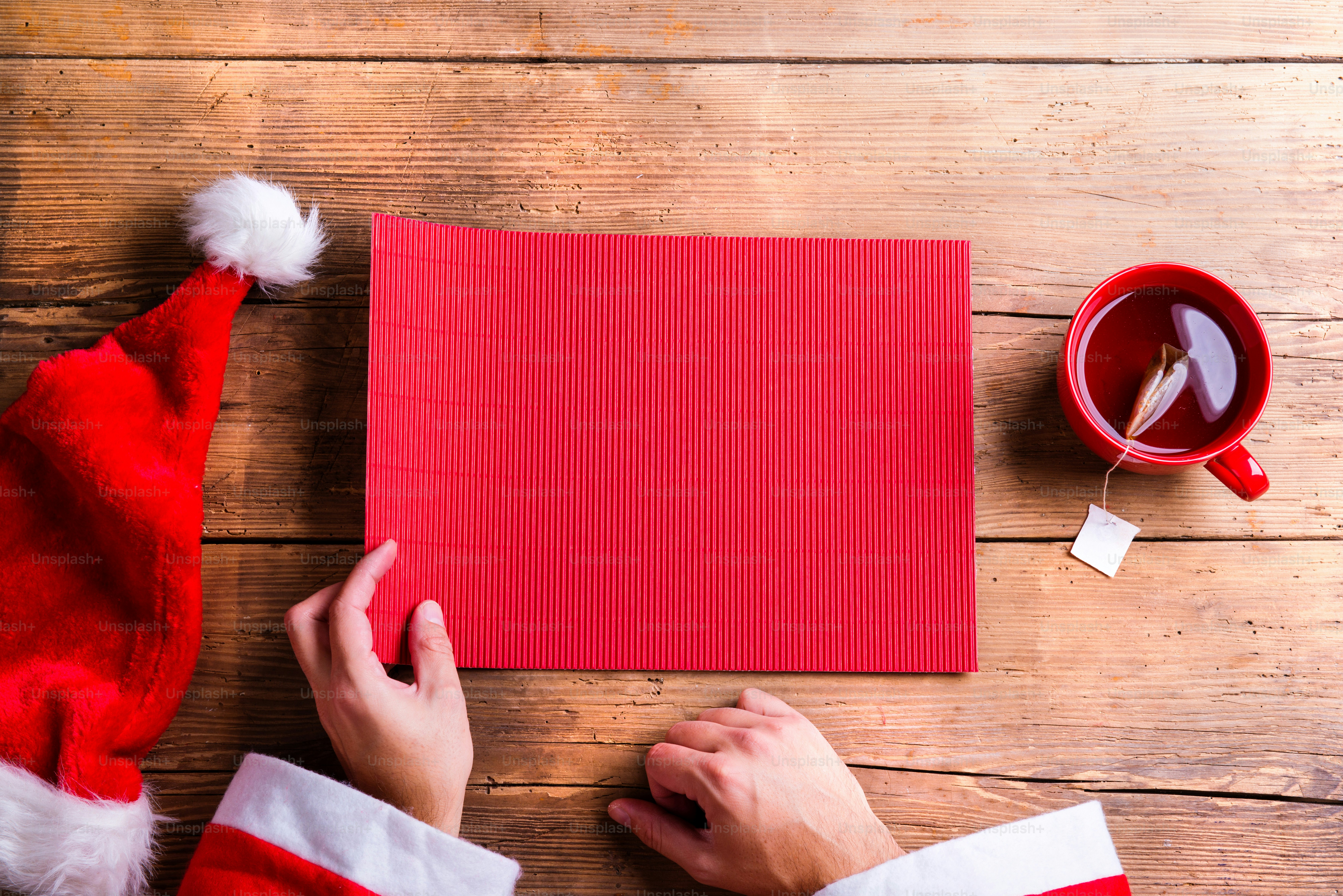 Santa Claus holding an empty wish list in his hands