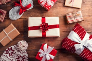 Christmas presents laid on a wooden table background