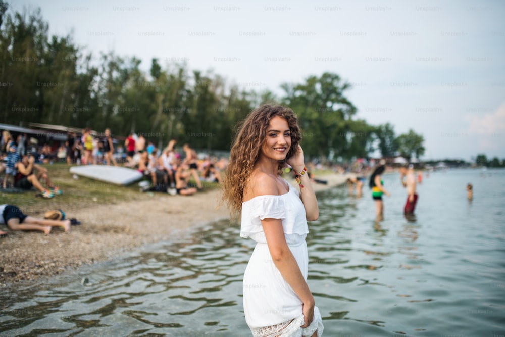 Junge Frau beim Sommerfest, im See stehend. Speicherplatz kopieren.
