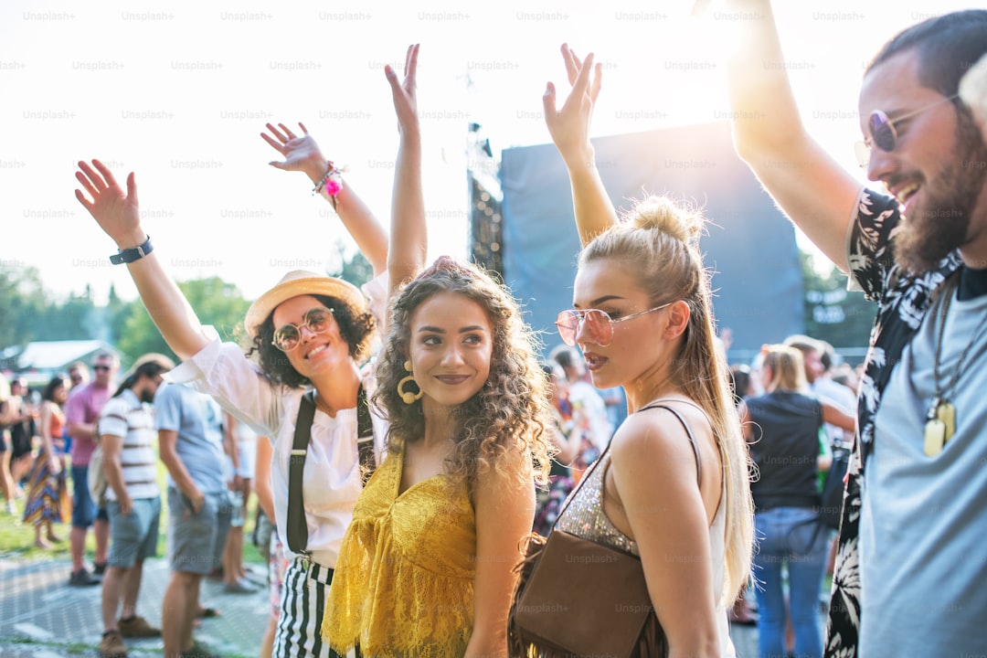 A front view portrait of group of young friends dancing at summer festival.