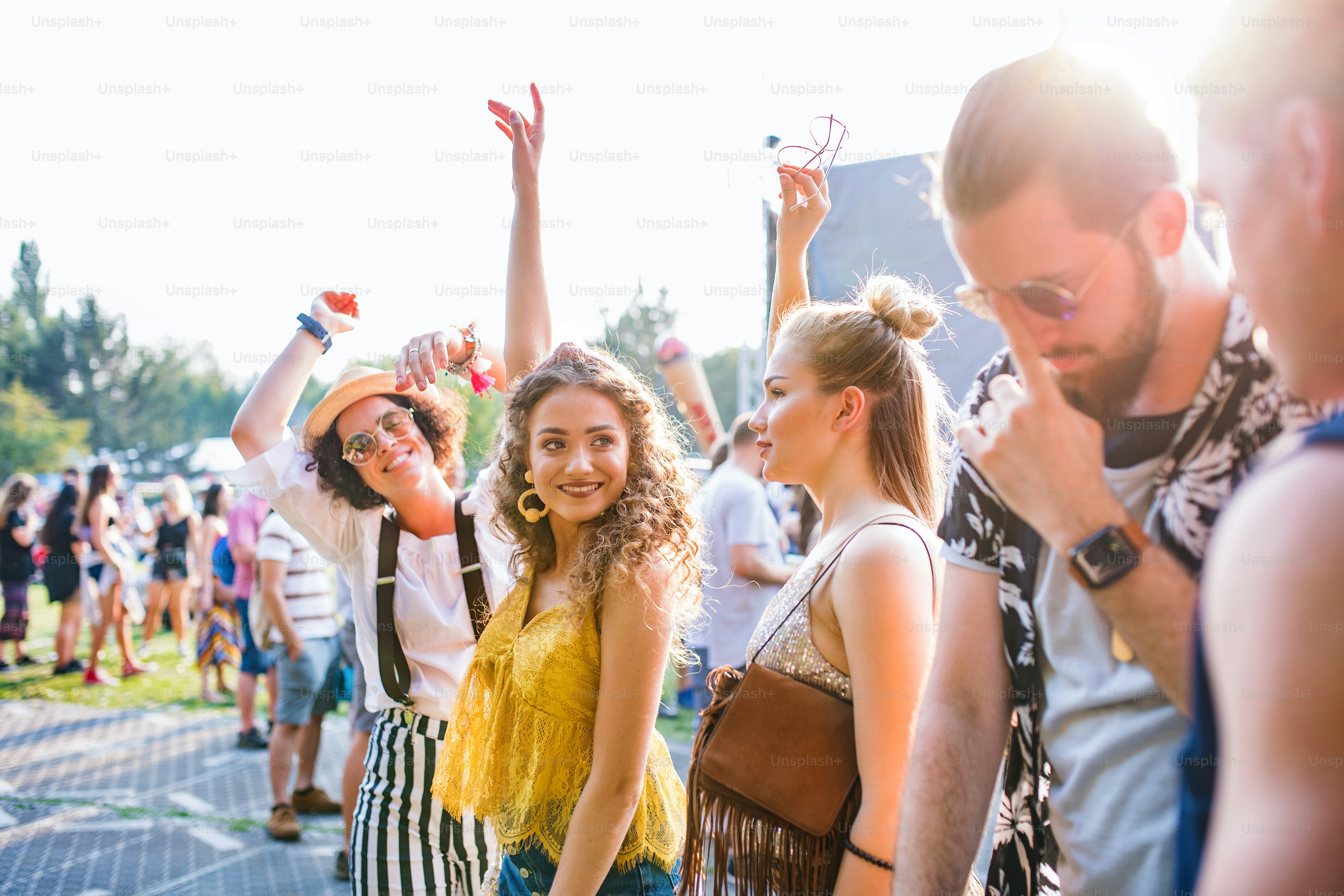 A group of cheerful young friends dancing at summer festival. photo ...