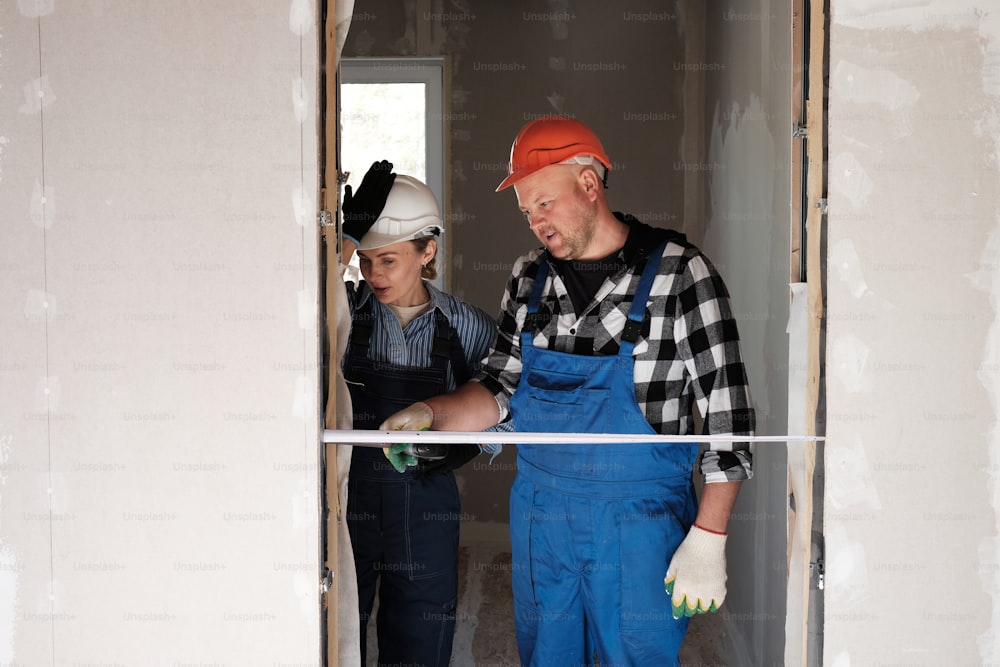 a man and a woman standing in a room under construction