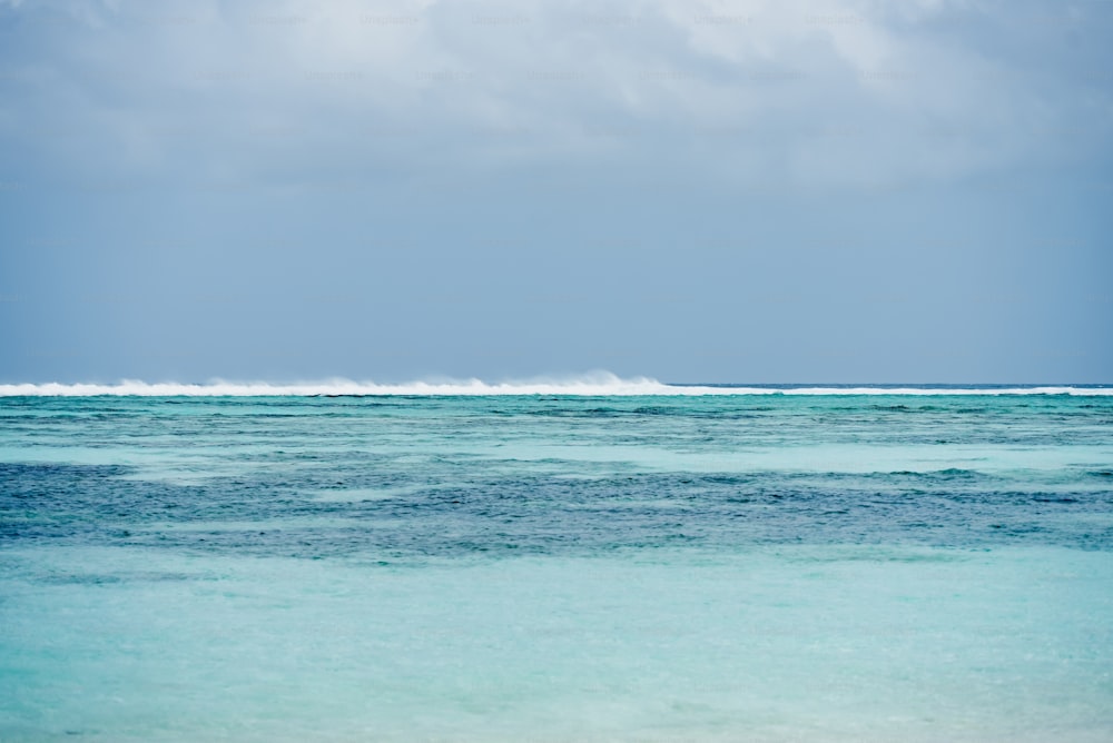 a body of water with a wave coming in