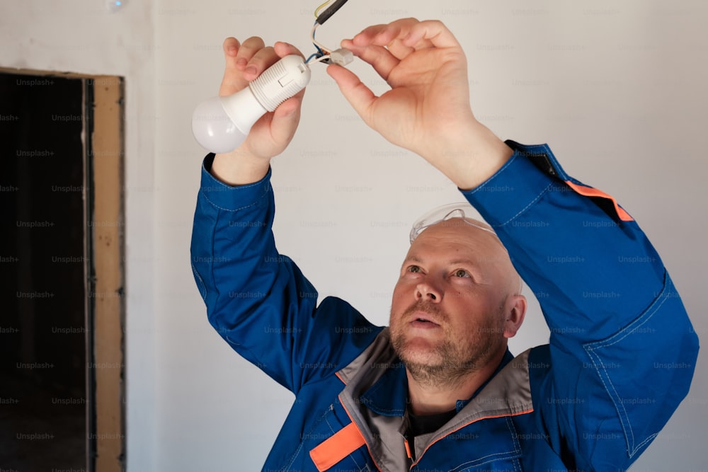 a man holding a pair of scissors above his head