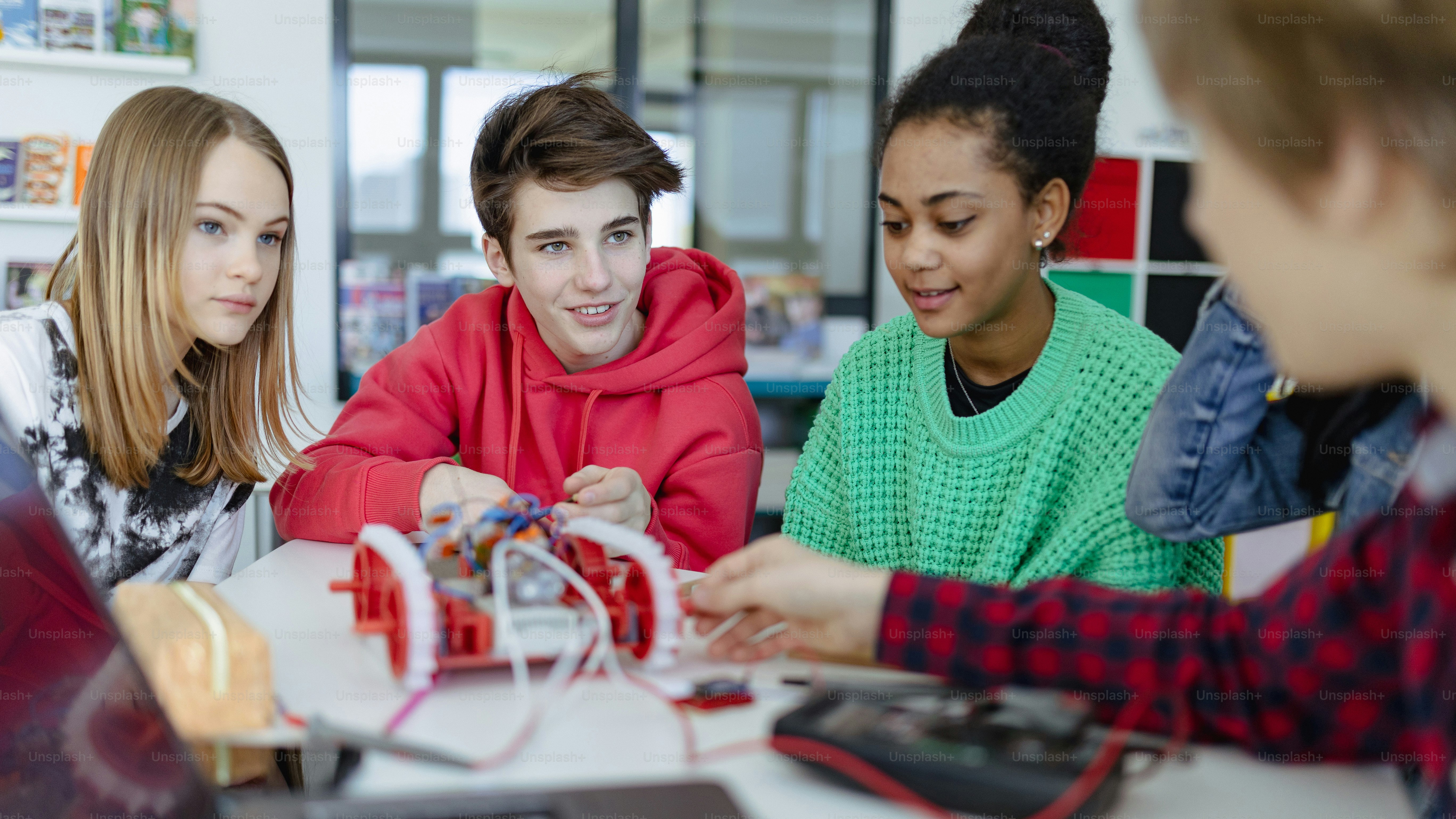 A group of high school students building and programming electric toys ...