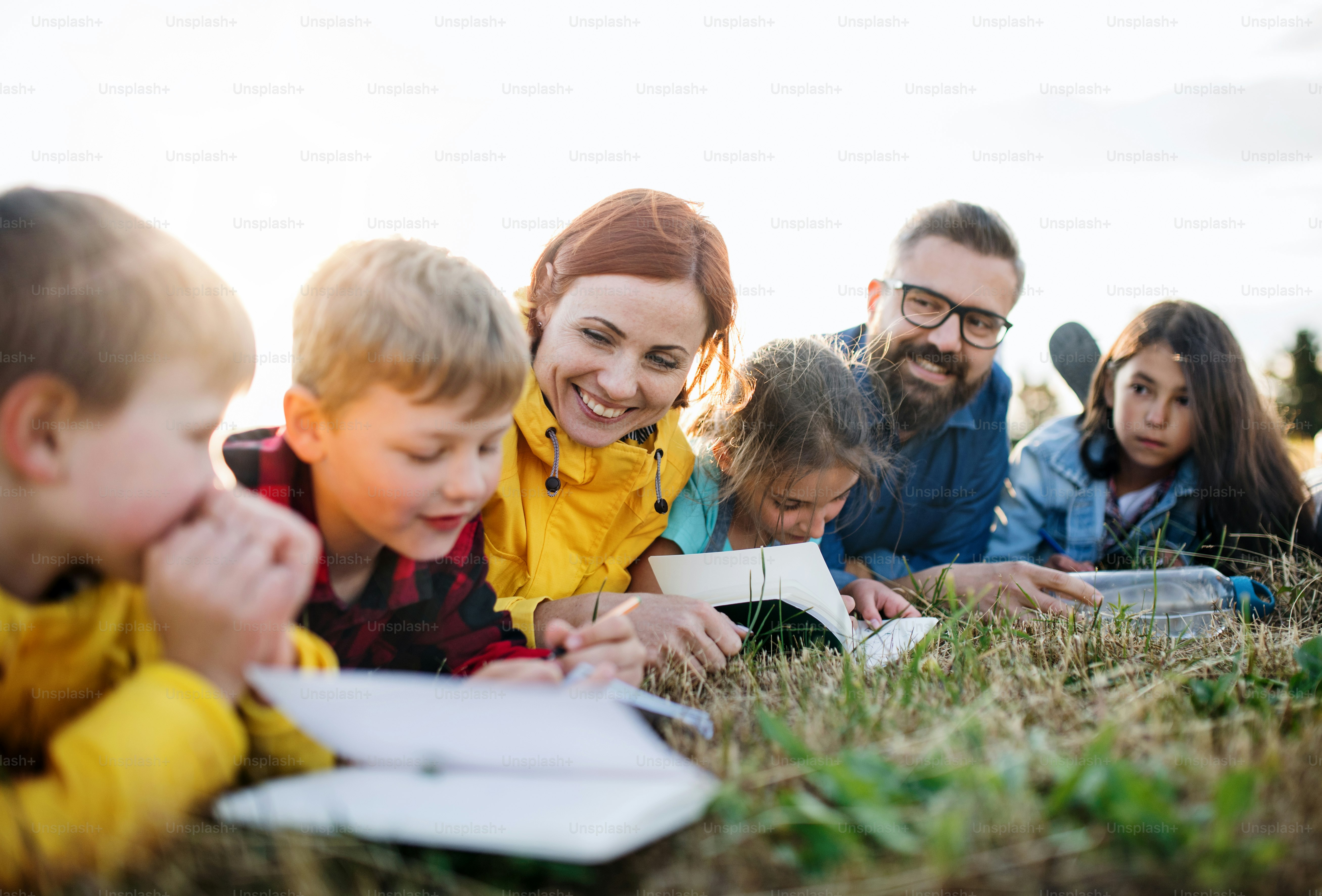 Um grupo de crianças pequenas em idade escolar com professor em viagem de campo na natureza.