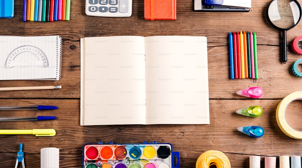 Desk with stationary and copy space. Studio shot on wooden background.