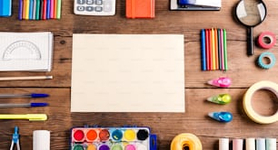 Desk with stationary and copy space. Studio shot on wooden background.