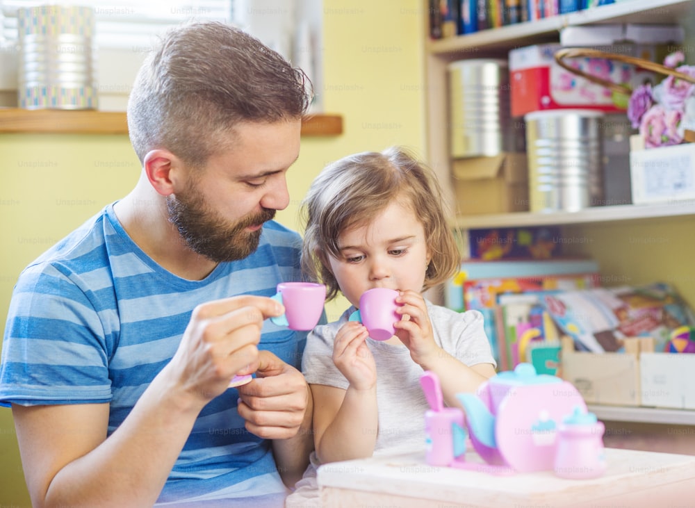 Young hipster father playing with his daughter