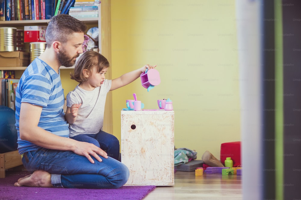 Young hipster father playing with his daughter