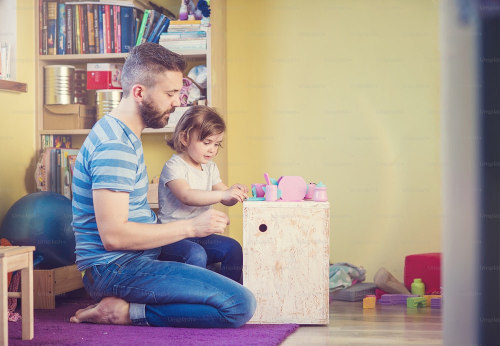 Young hipster father playing with his daughter