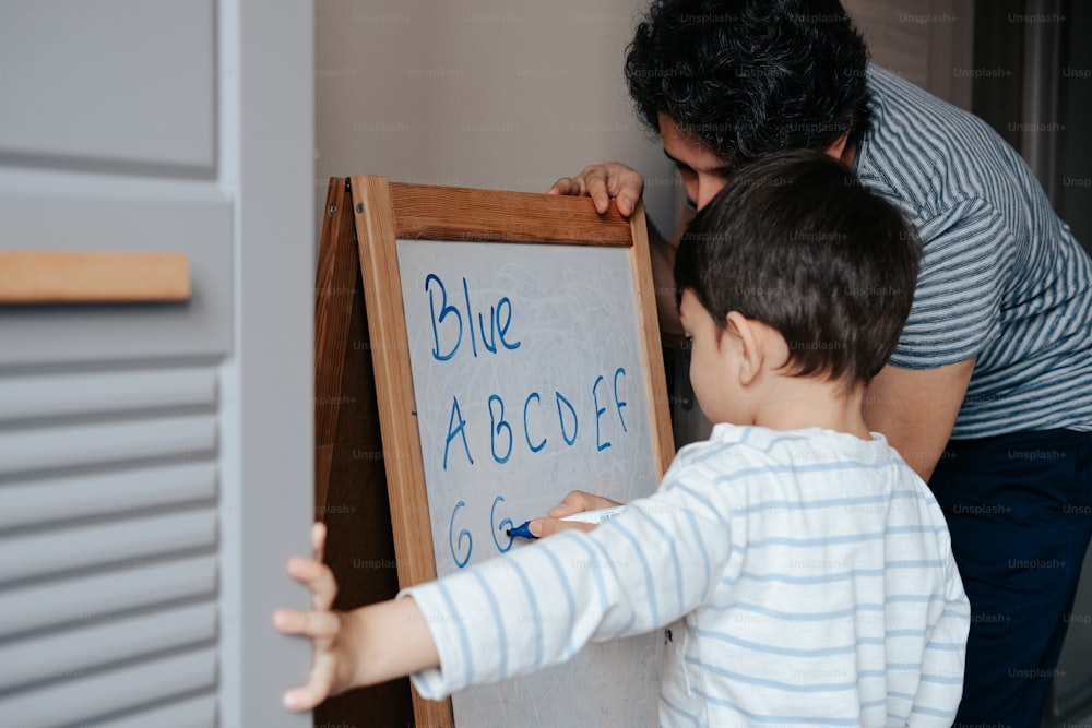 a man and a young boy standing in front of a sign