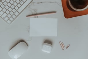 a desk with a keyboard, mouse, and paper