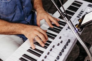 a man sitting at a keyboard with his hands on the keys