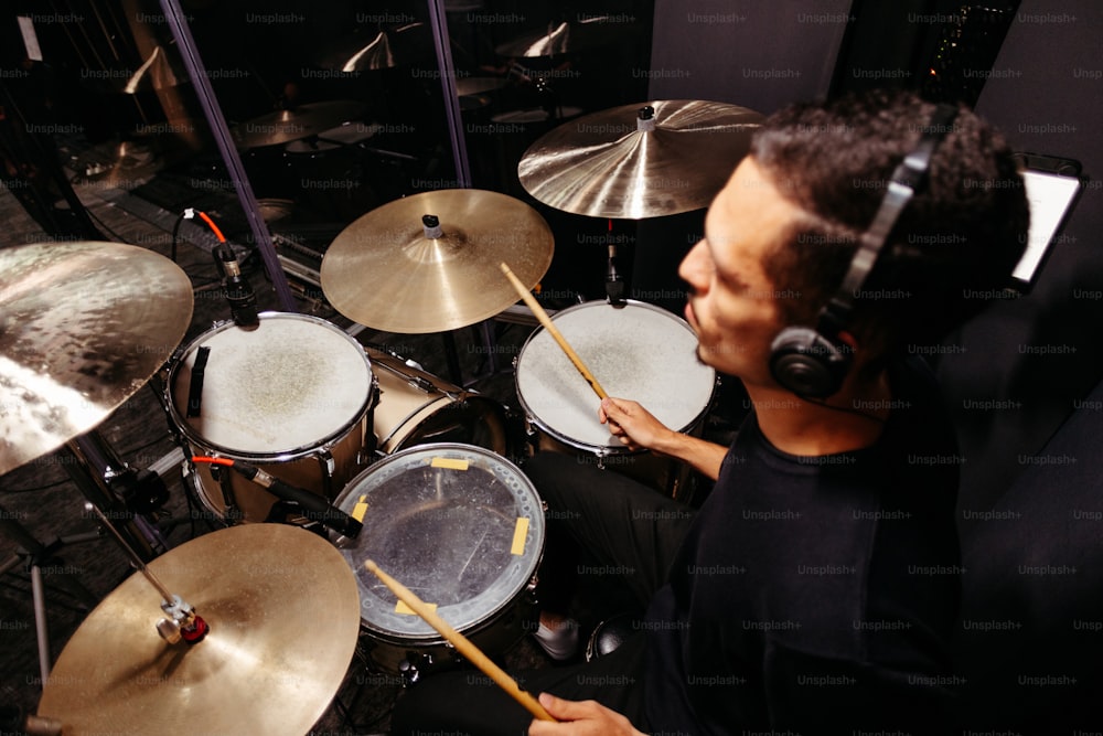 a man with headphones on playing drums