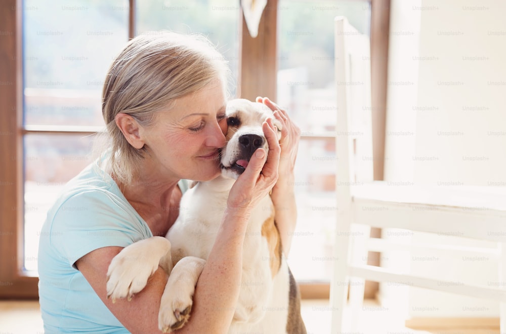 Donna anziana con il cane all'interno della sua casa.