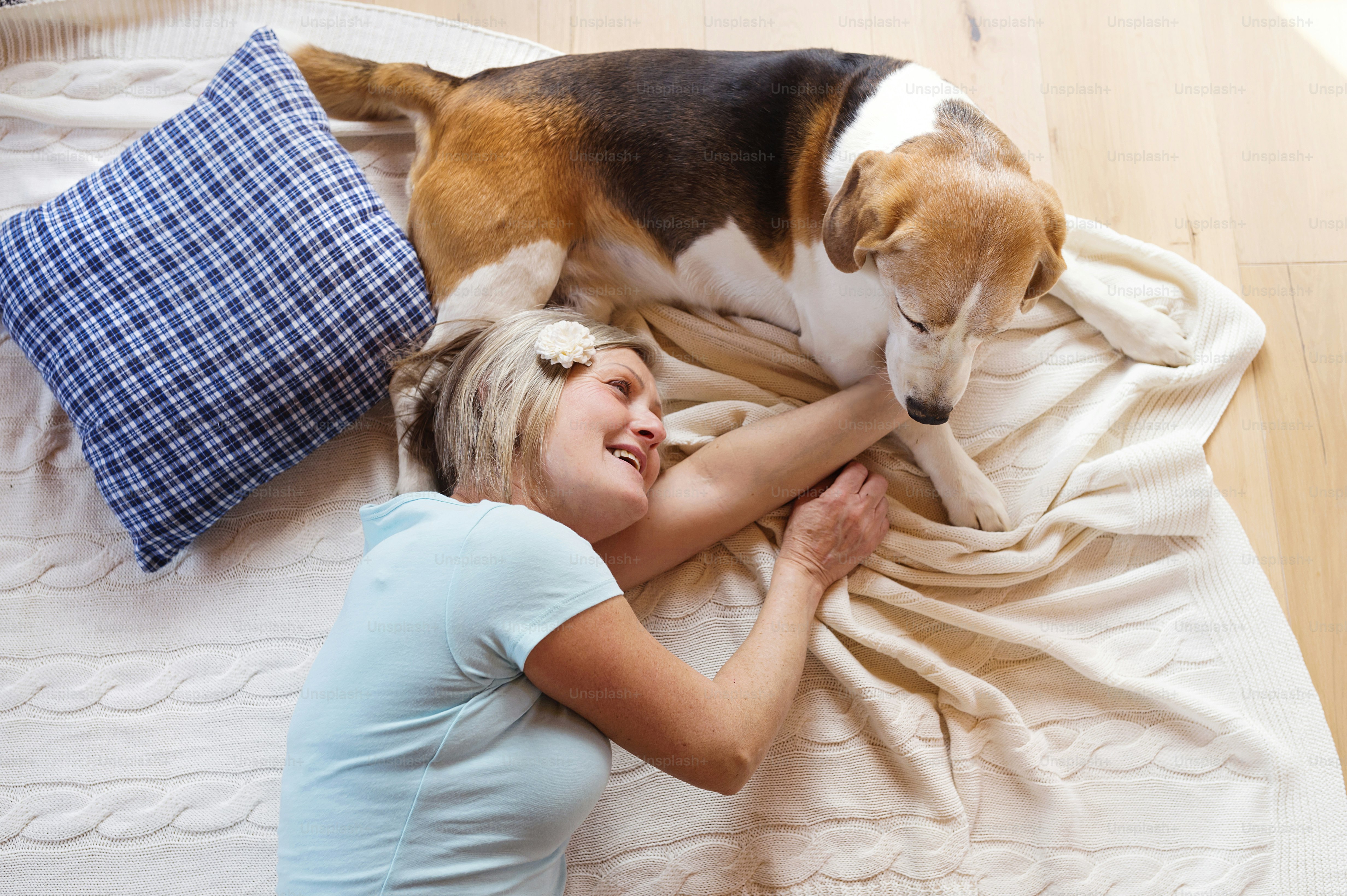 Senior woman with dog inside of her house.