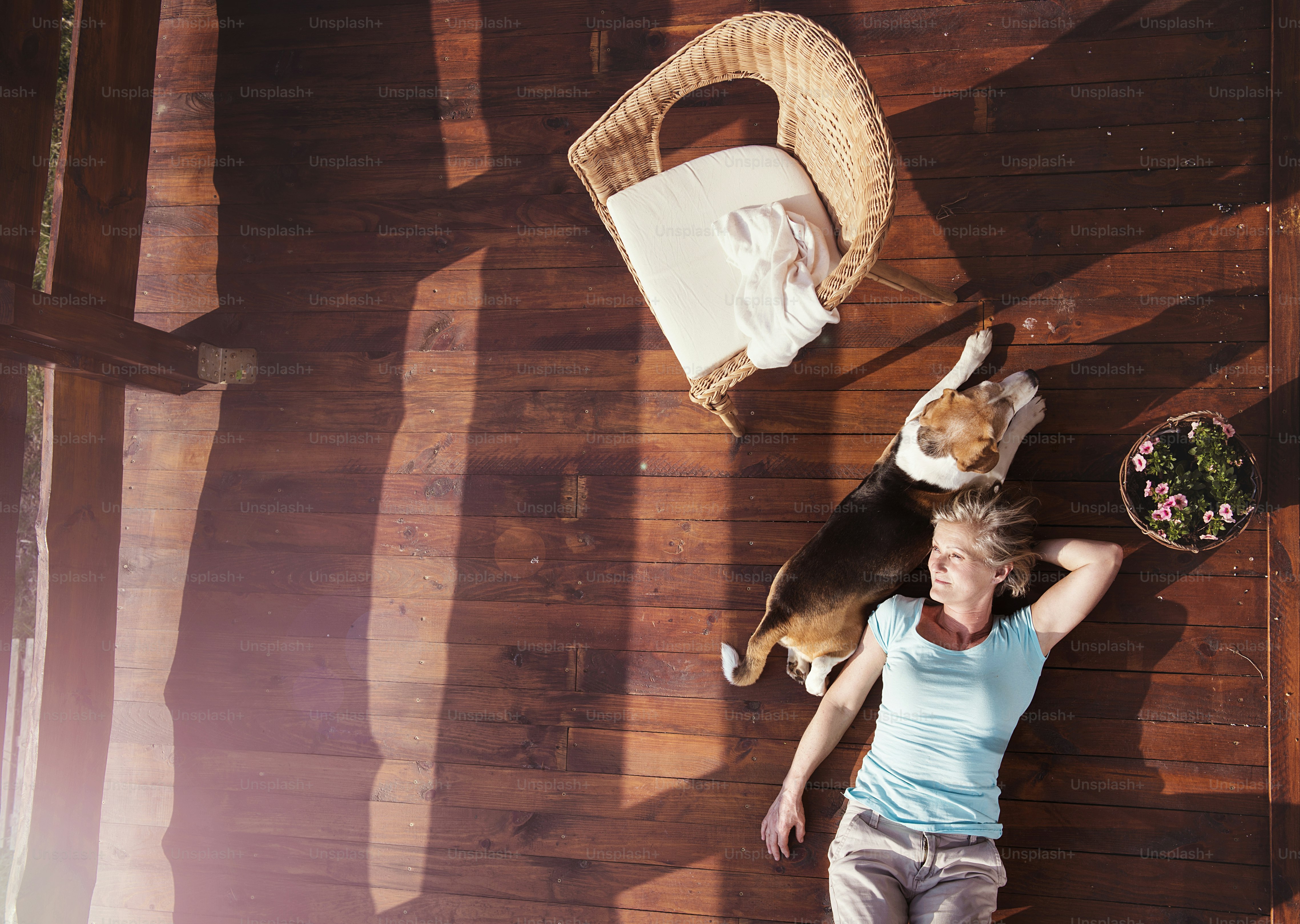 Senior woman with her dog on a terrace of her house.