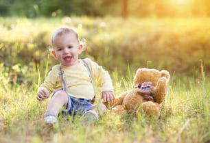 Little boy playing and having fun outside in a park