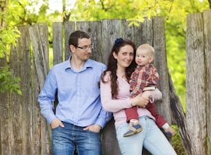 Happy family spending time with son in nature