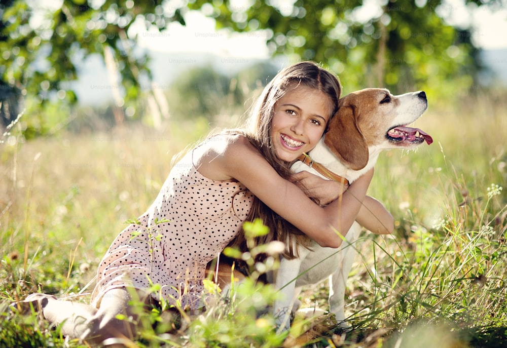 Portrait of a teenage girl with her beautiful dog outdoors