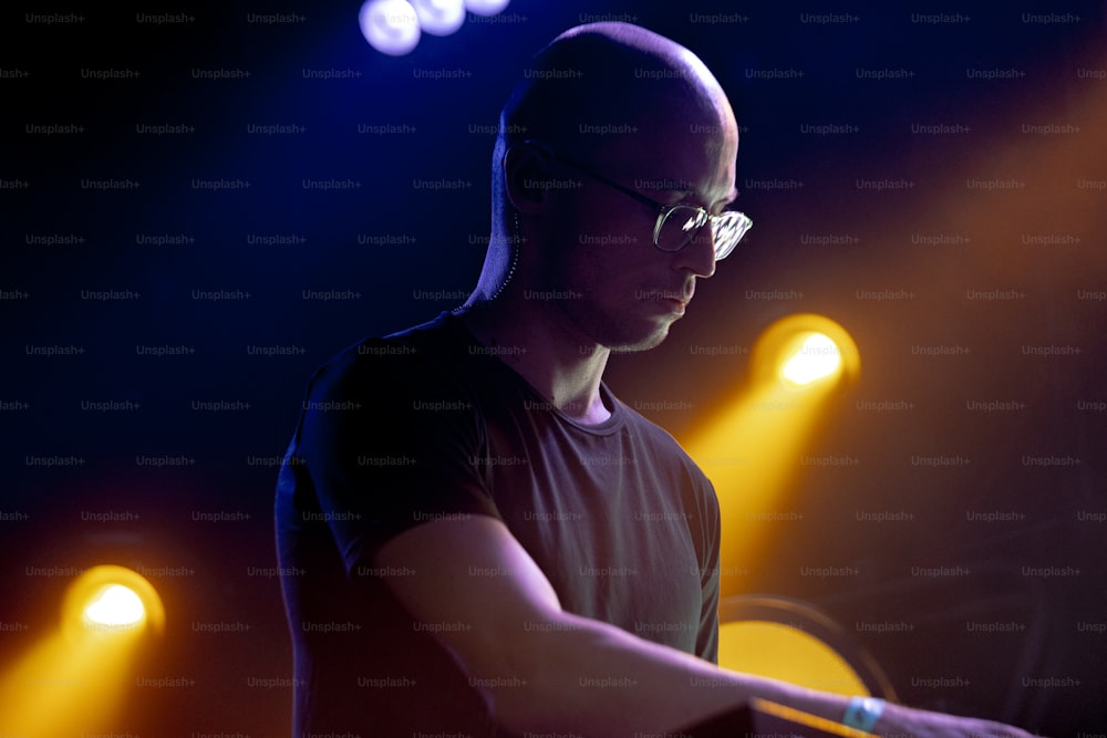Un uomo in piedi davanti a una tastiera su un palcoscenico