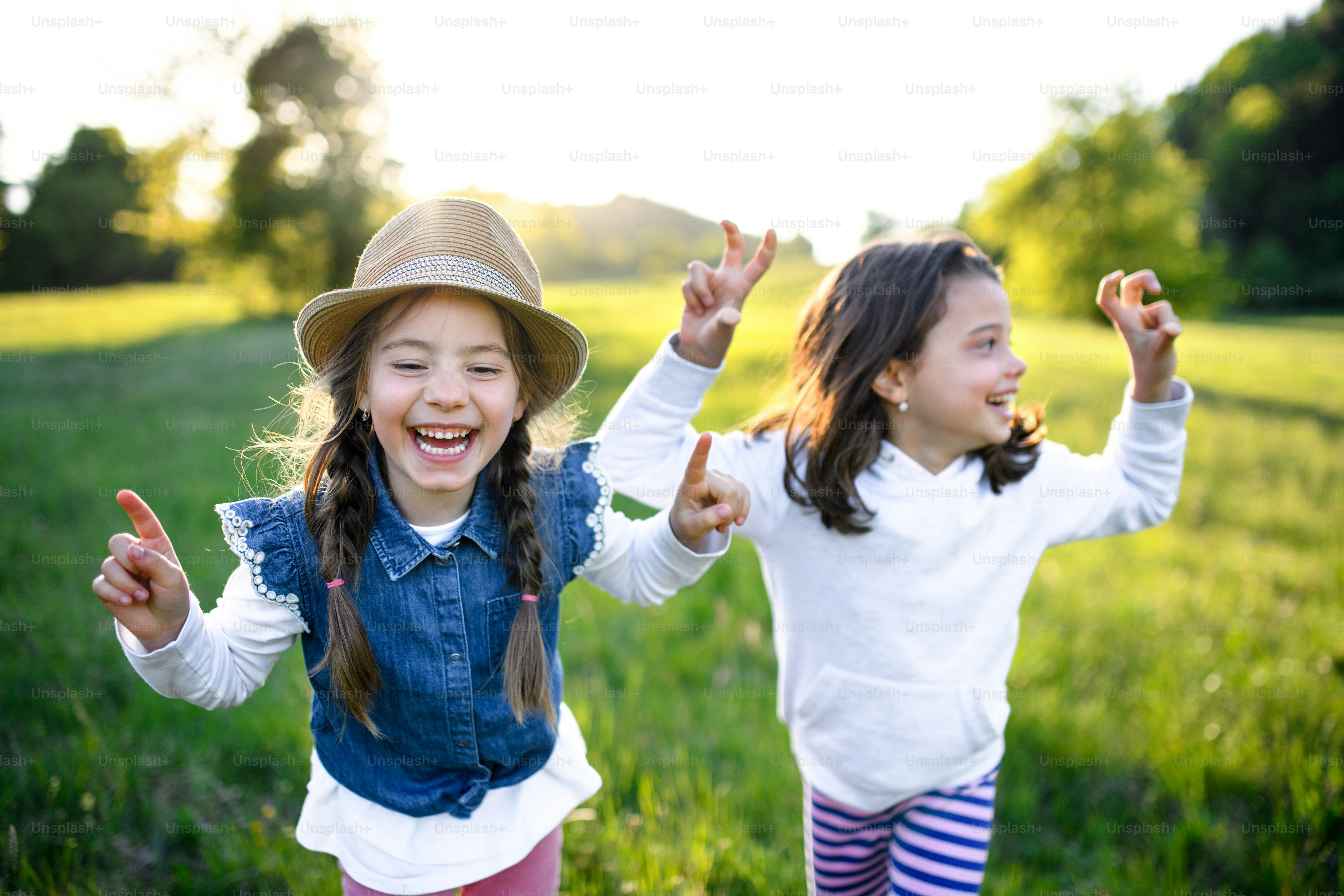 Portrait of cheerful small girl running outdoors in spring nature ...