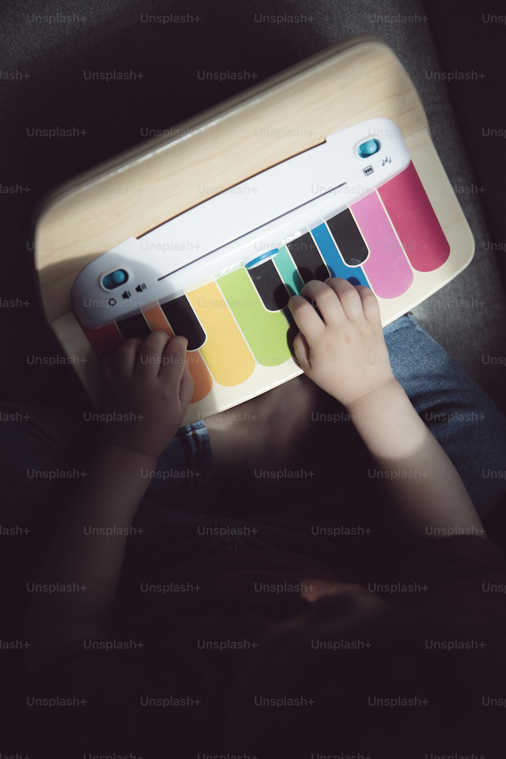 a child is playing with a piano toy