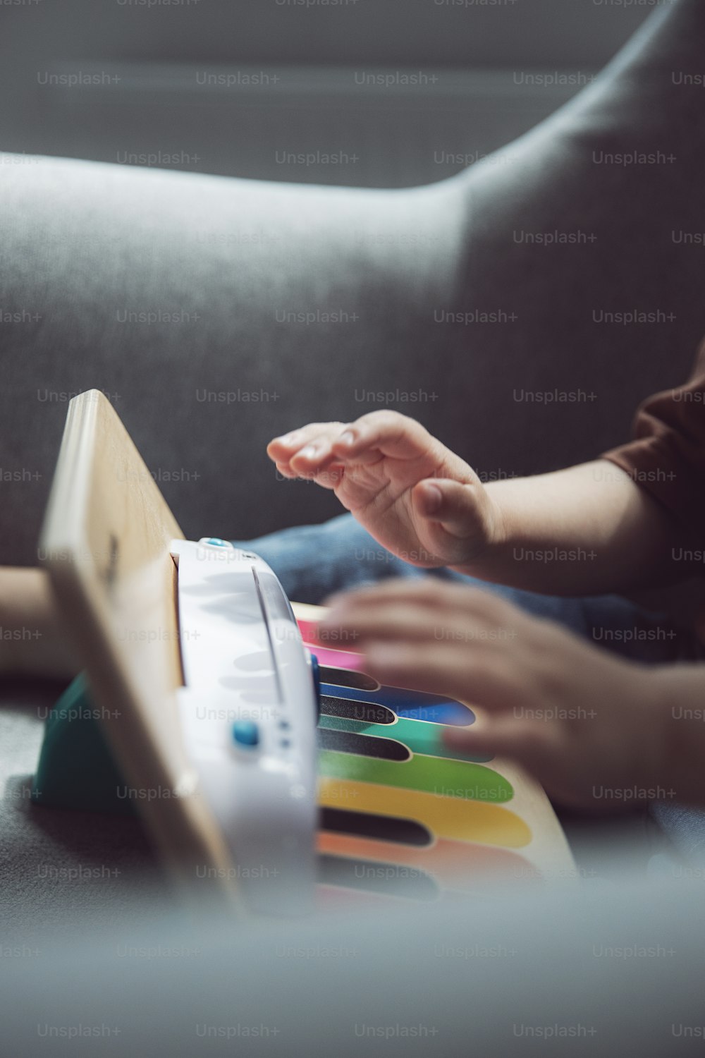 a child is playing with a toy piano
