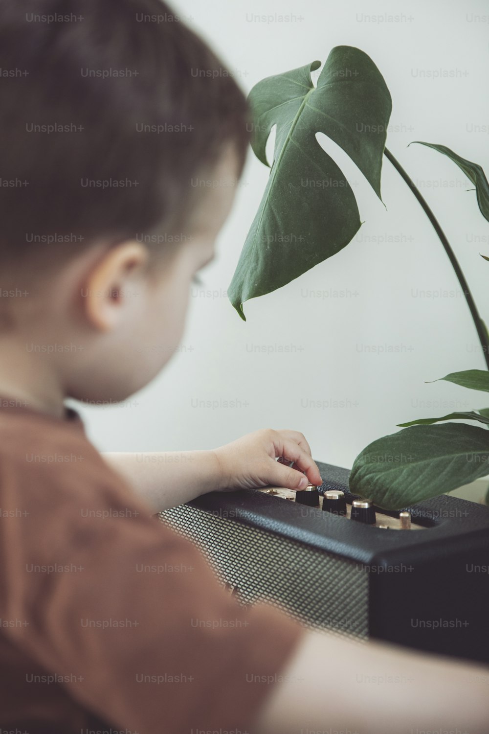 a young boy is playing with a keyboard
