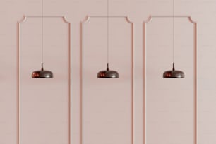 a row of hanging lights on a pink wall