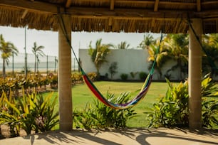 a hammock hanging from a thatched roof