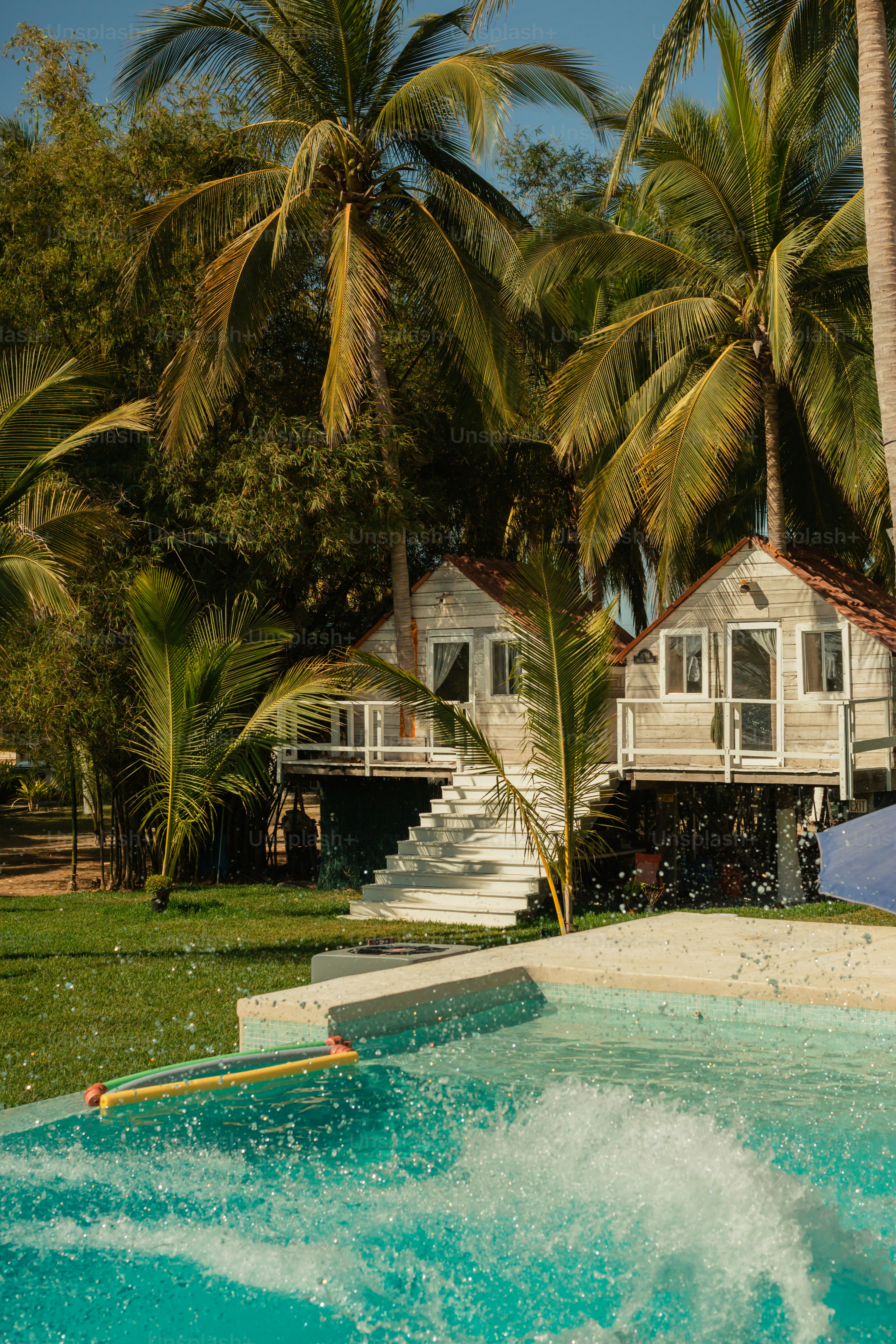 a house sitting next to a lush green forest