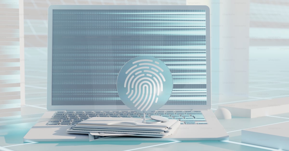 A laptop computer with a fingerprint on it photo – Internet banking ...