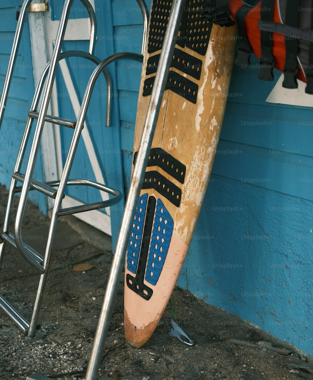 a pair of surfboards leaning against a blue wall