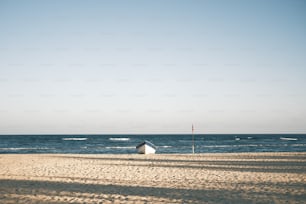 a boat sitting on top of a sandy beach