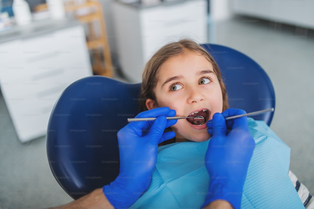 Annual dental check-up of small child in dentist surgery.