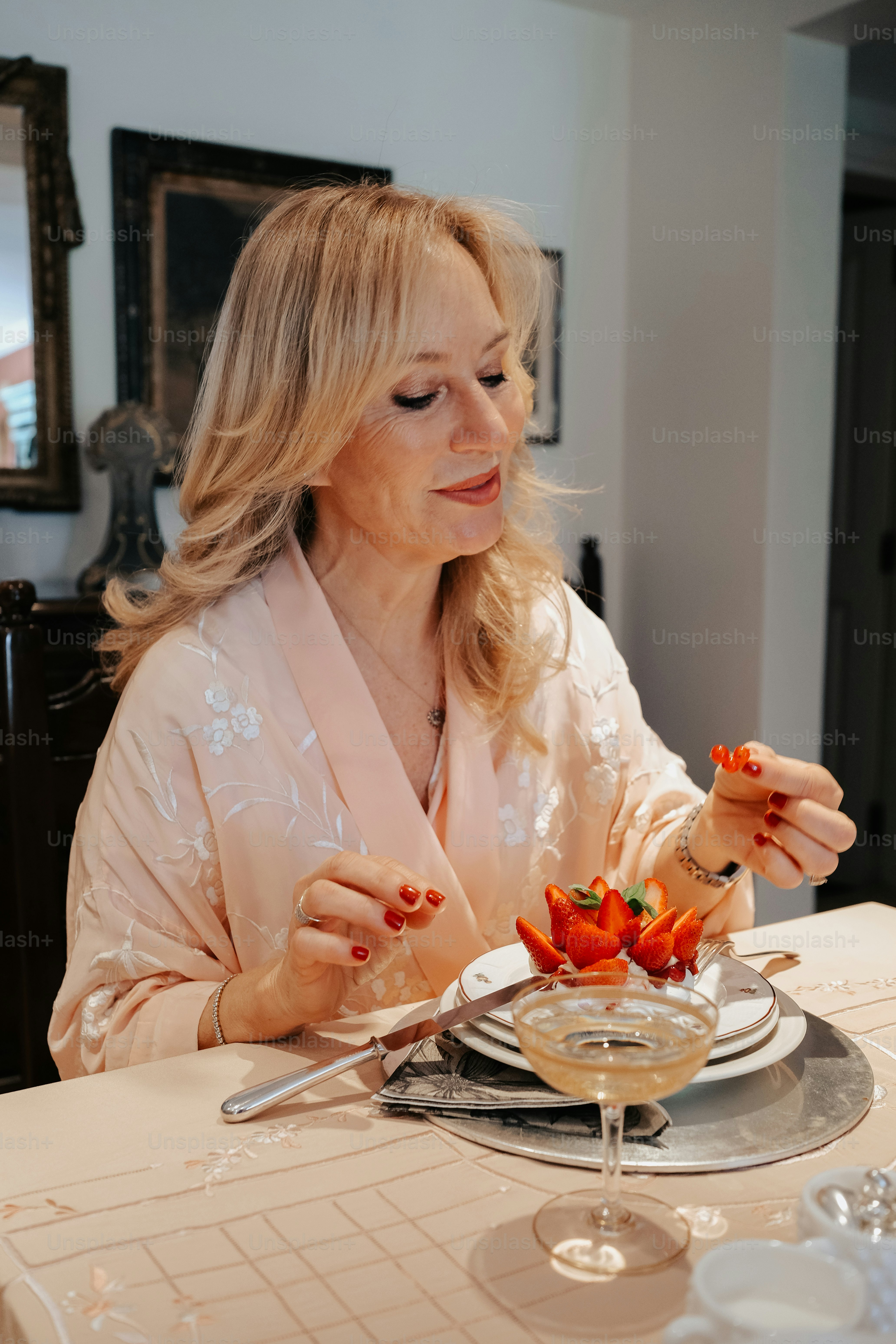 a woman sitting at a table with a plate of food