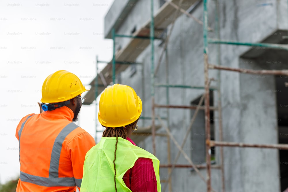 a couple of construction workers standing next to each other