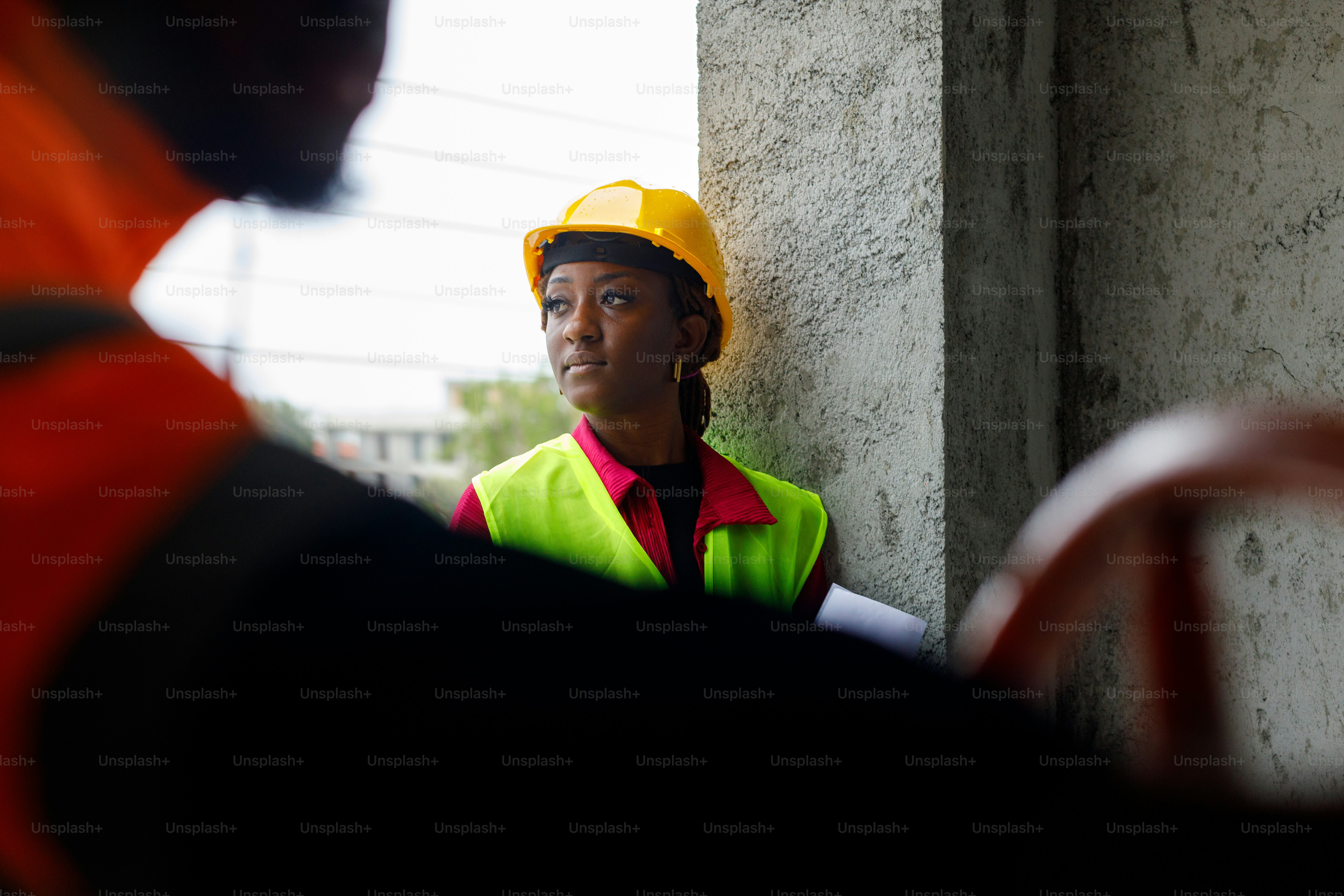 a woman wearing a safety vest and a hard hat